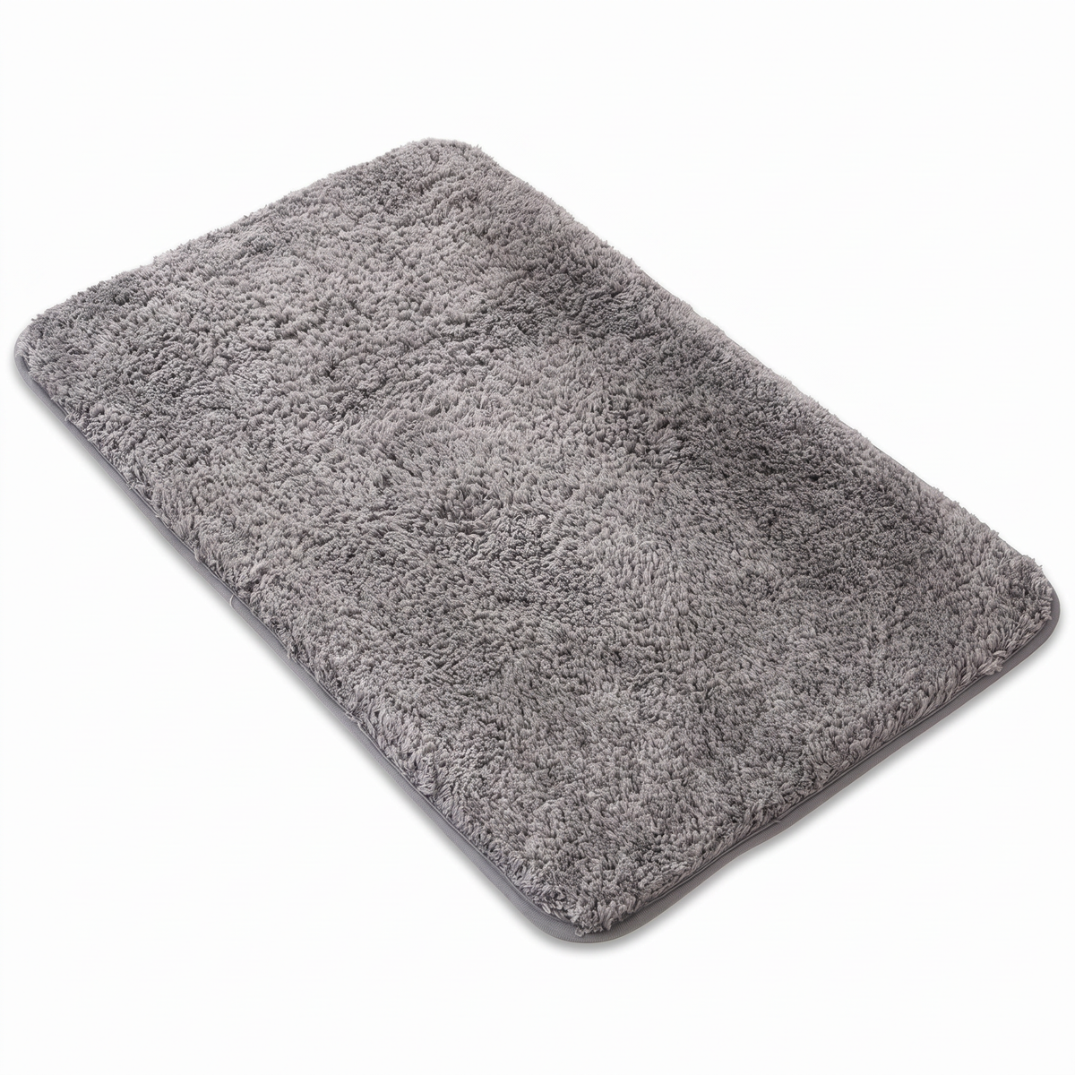 Grey plush microfiber bath mat on a white background